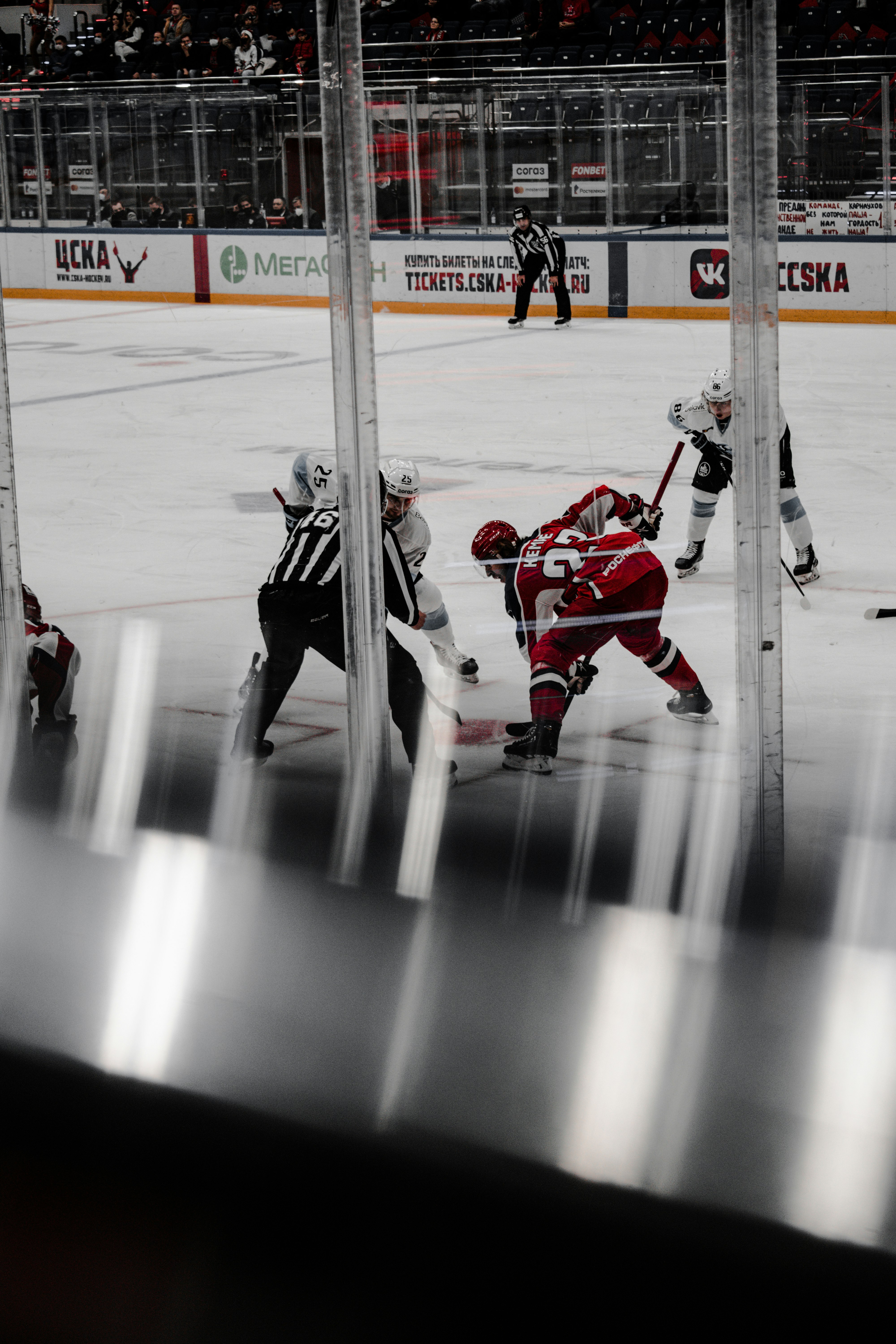 2 men in red jersey shirt playing hockey