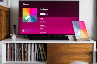 a flat screen tv sitting on top of a white shelf