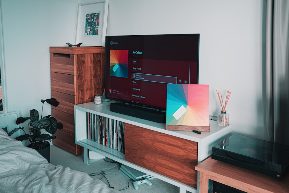 black flat screen tv on white wooden tv rack