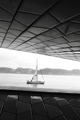 A serene view of the Brisamar sailboat inn's minimalist exterior at sunset, highlighting clean lines and natural surroundings.