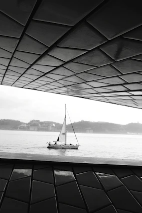 A serene view of the Brisamar sailboat inn's minimalist exterior at sunset, highlighting clean lines and natural surroundings.