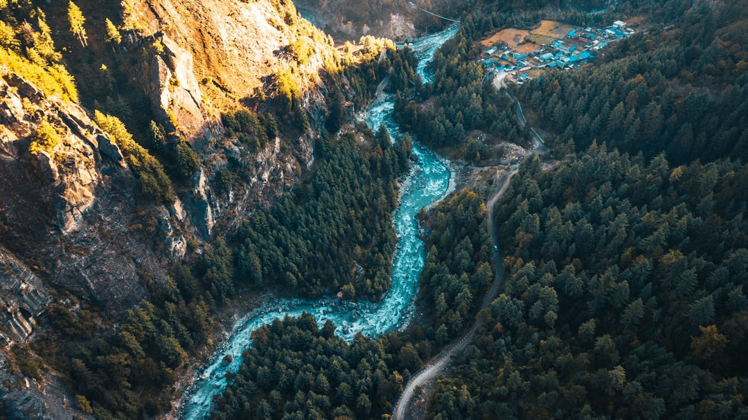 aerial view of river between rocky mountains during daytime