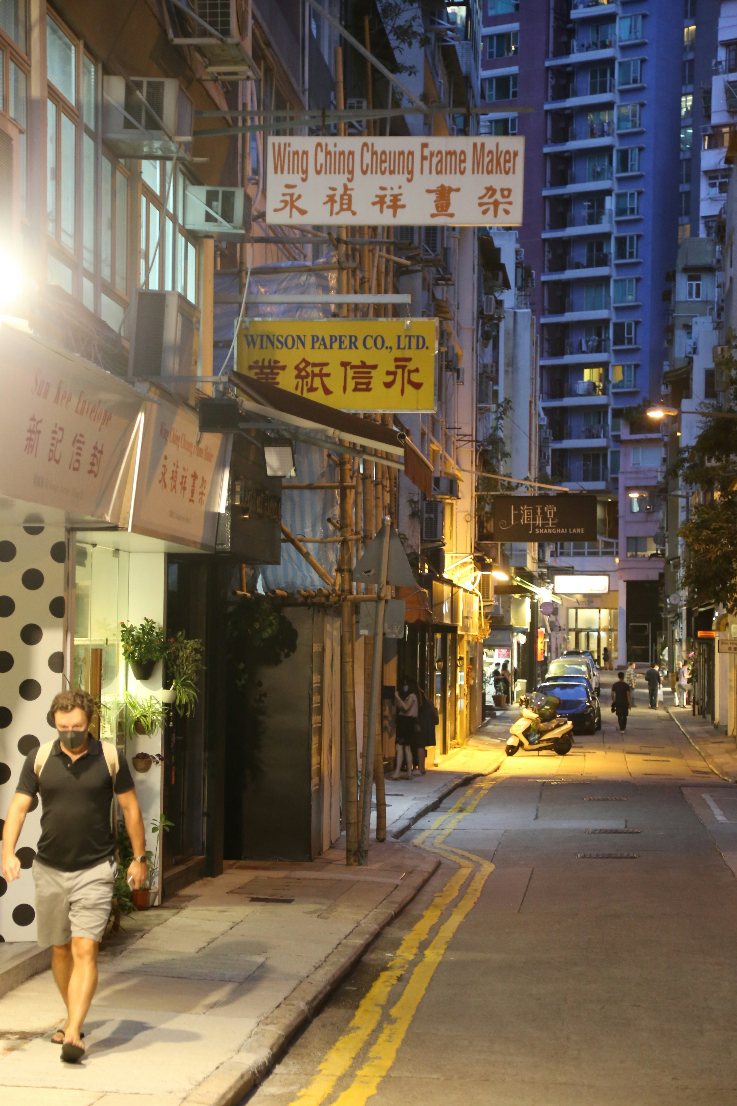 Man walking in empty street at night time 