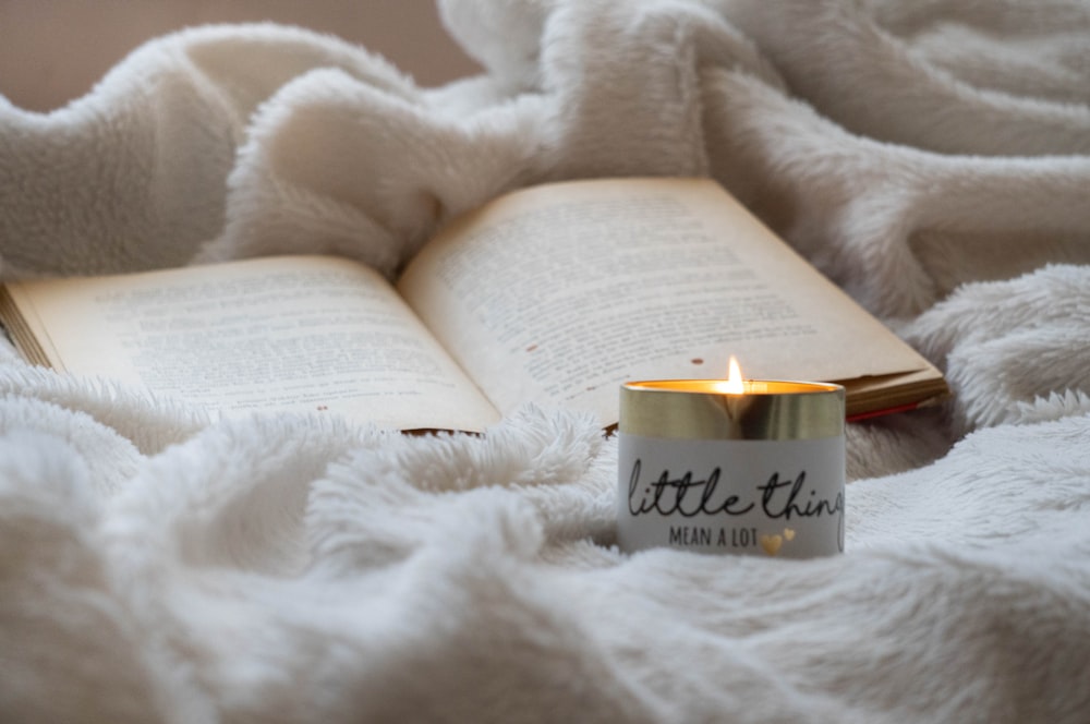 white candle on white textile