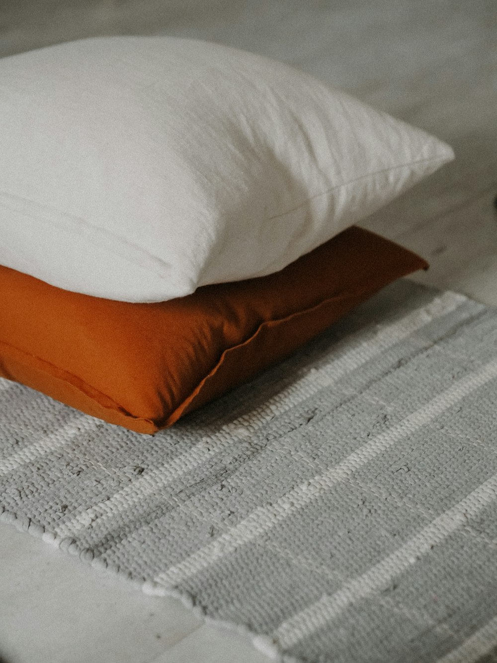 white and brown throw pillow on white textile