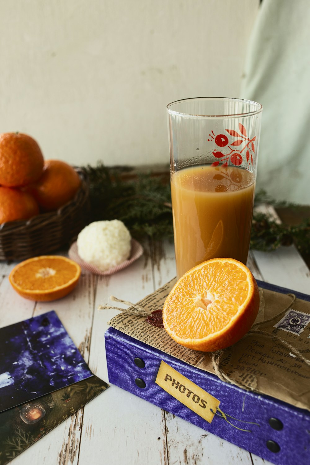 orange juice in clear drinking glass beside sliced orange fruit
