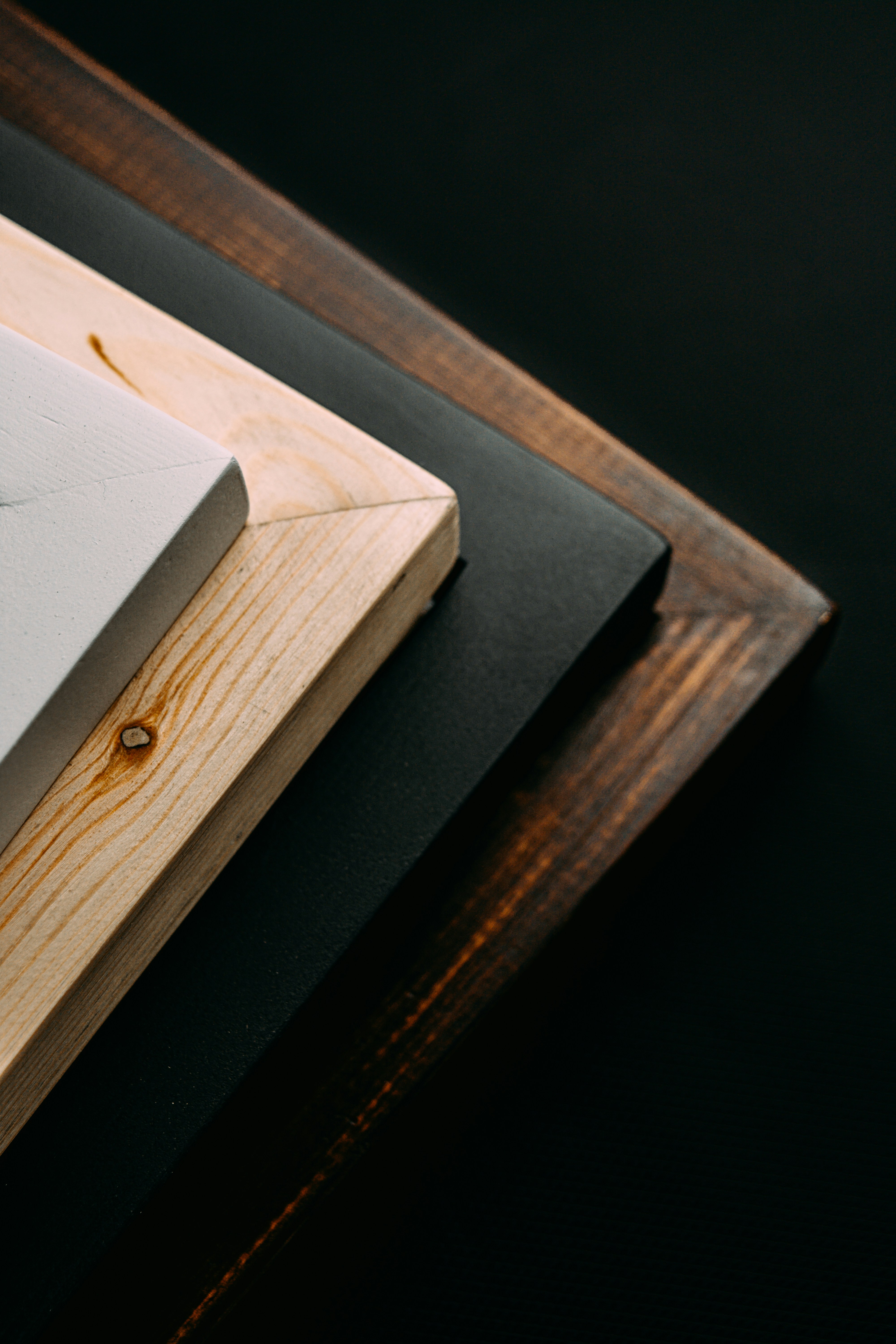 wood frames in different color on black background 