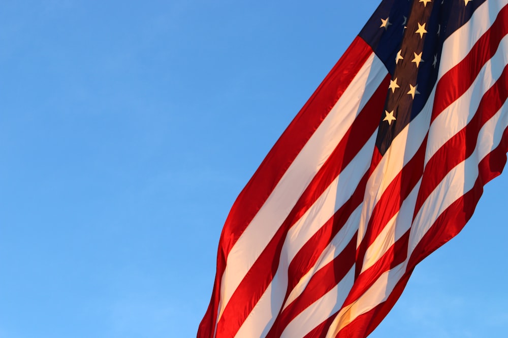 us a flag under blue sky during daytime