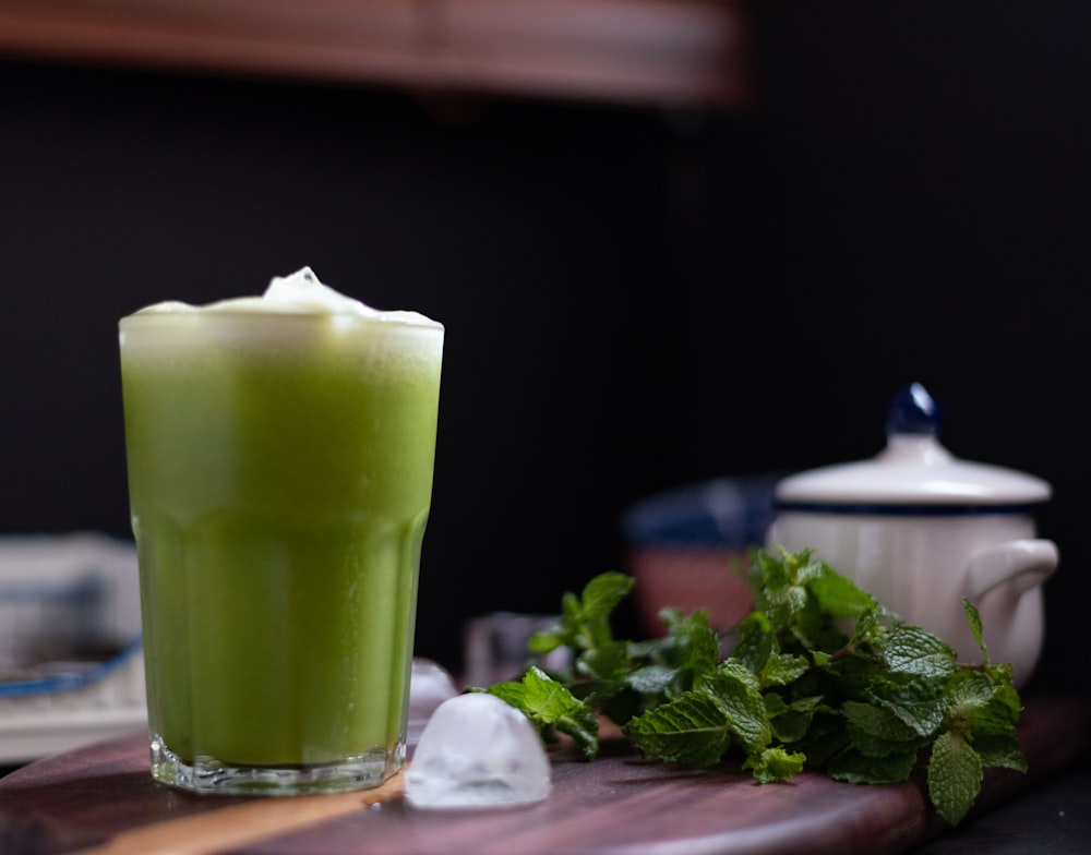 green liquid in clear drinking glass