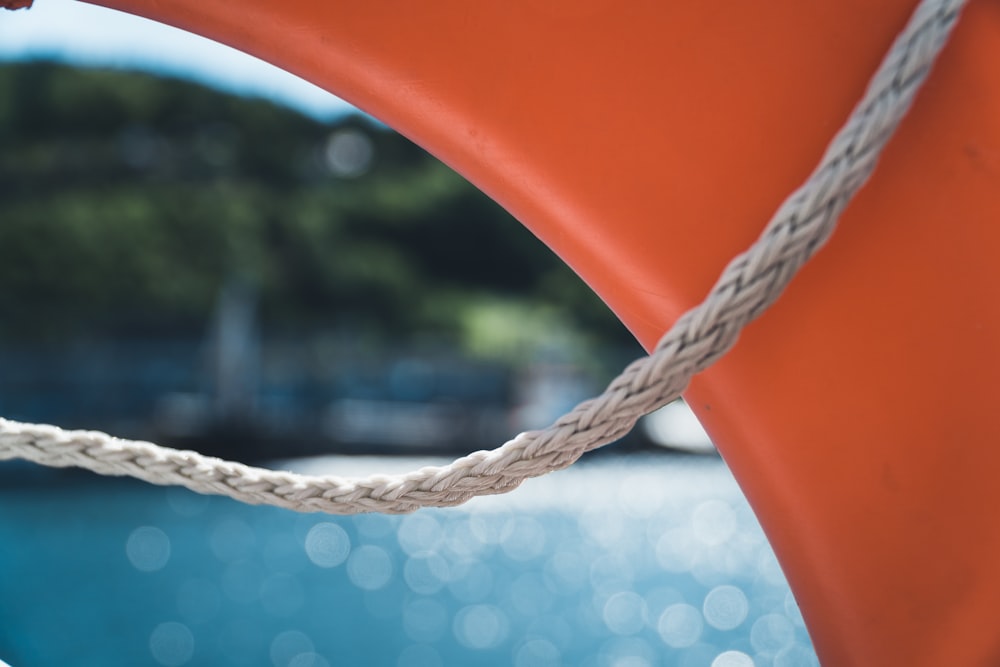 white rope on orange plastic chair