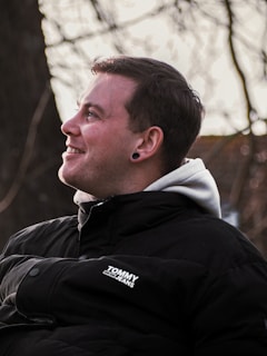 man in black and white adidas jacket