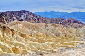 brown rocky mountain under blue sky during daytime