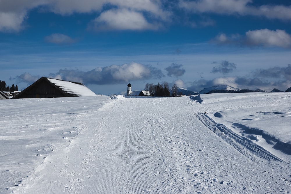 snow covered field under blue sky during daytime