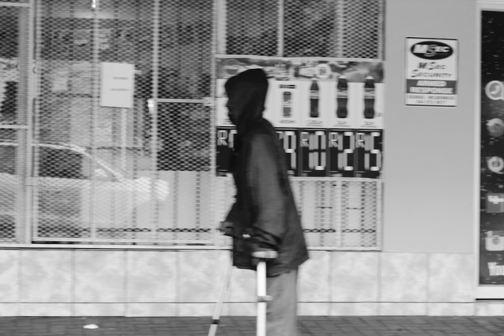 woman in black coat standing on gray concrete floor