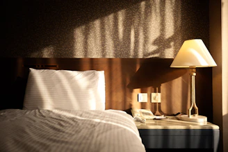 white bed linen near brown table lamp