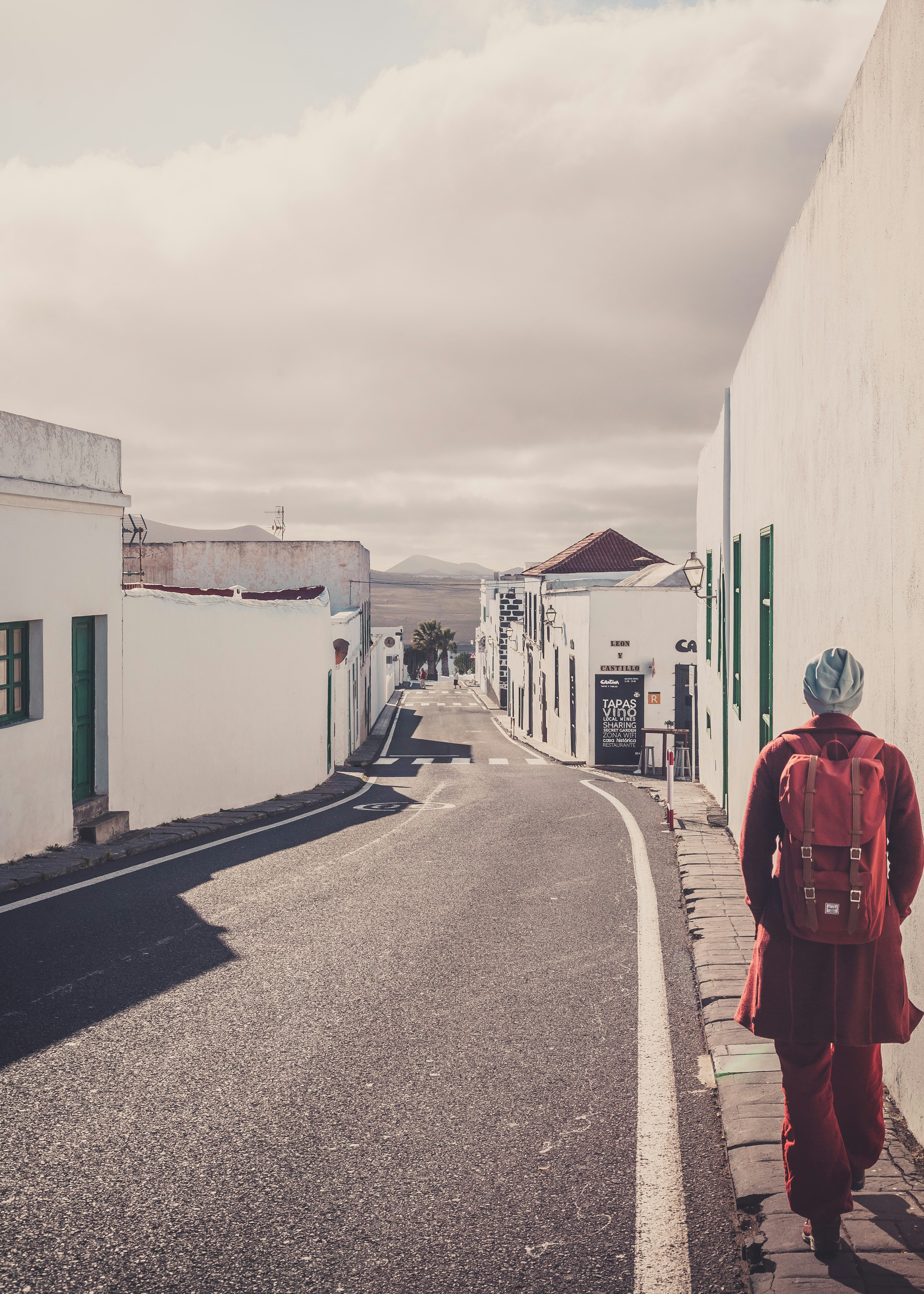 a person walking down a street with a backpack