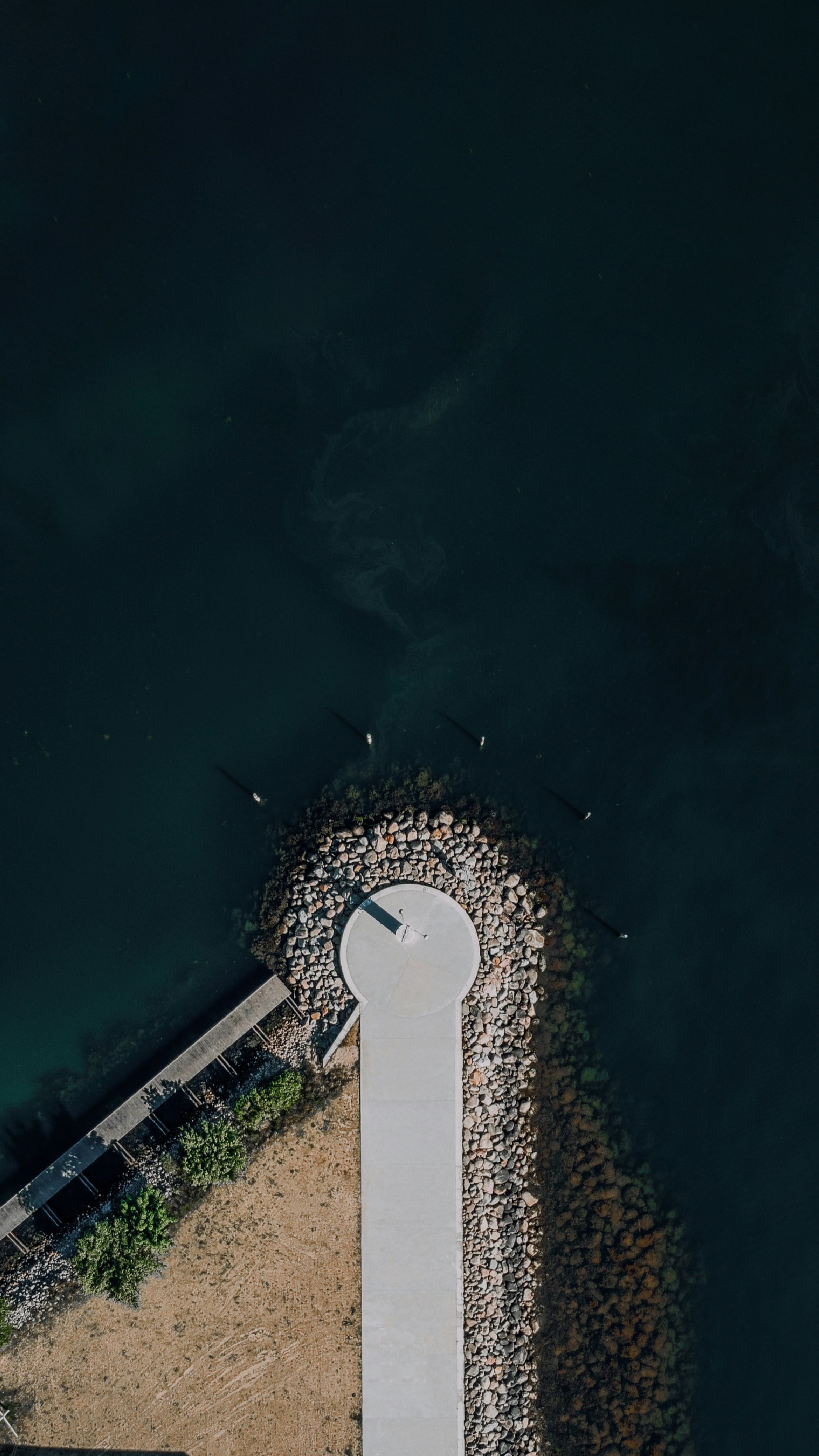 aerial view of white and gray house near body of water during daytime