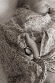 silver wedding band on brown textile