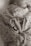 A newborn baby wrapped in a floral-patterned fabric, with their tiny feet adorned with two rings, one with a diamond stone.