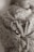 A newborn baby wrapped in a floral-patterned fabric, with their tiny feet adorned with two rings, one with a diamond stone.