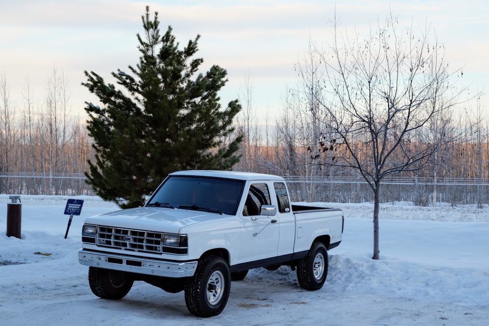 white chevrolet crew cab pickup truck on snow covered ground