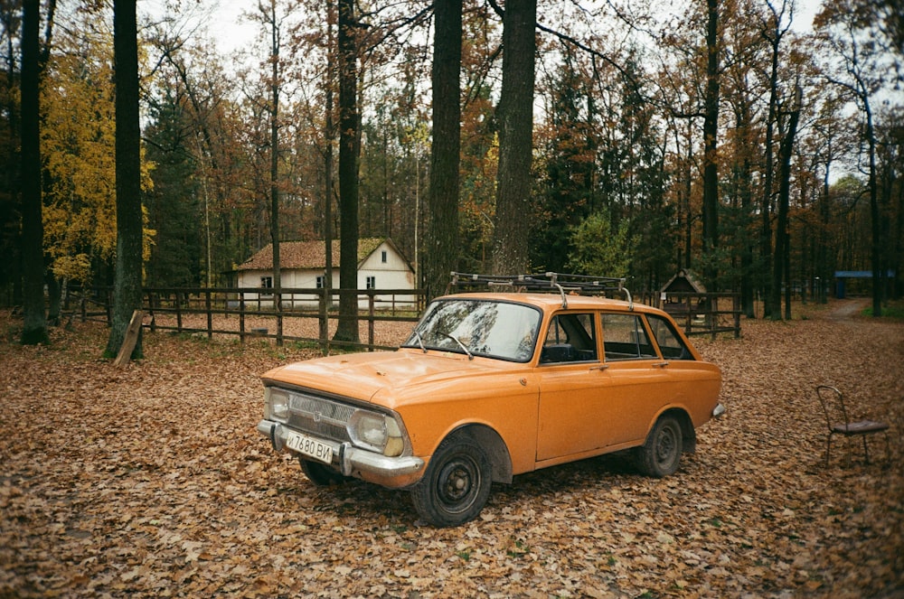 brown sedan parked near brown wooden house during daytime