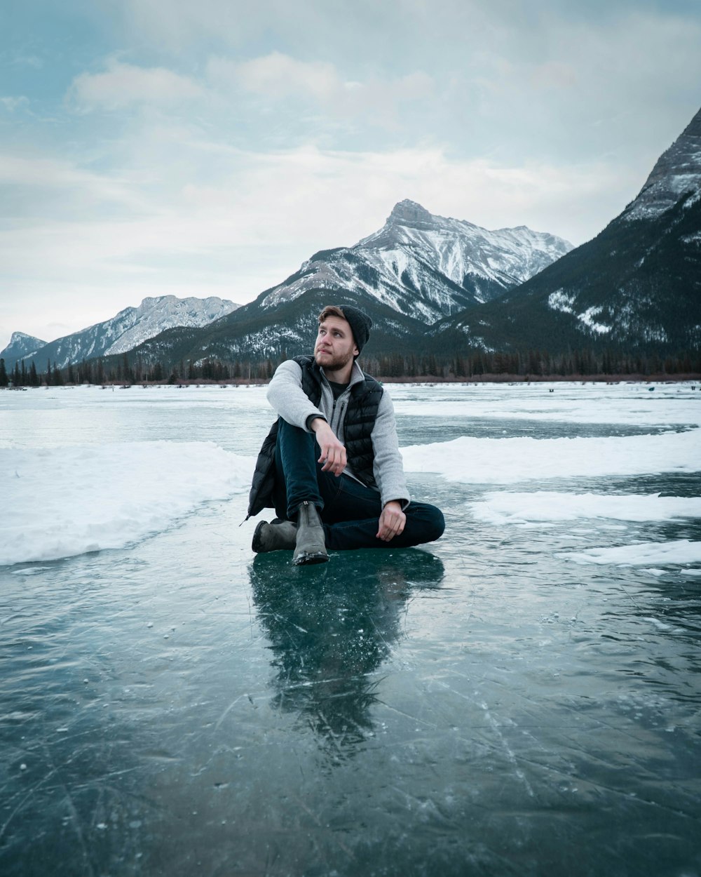 woman in white jacket sitting on water