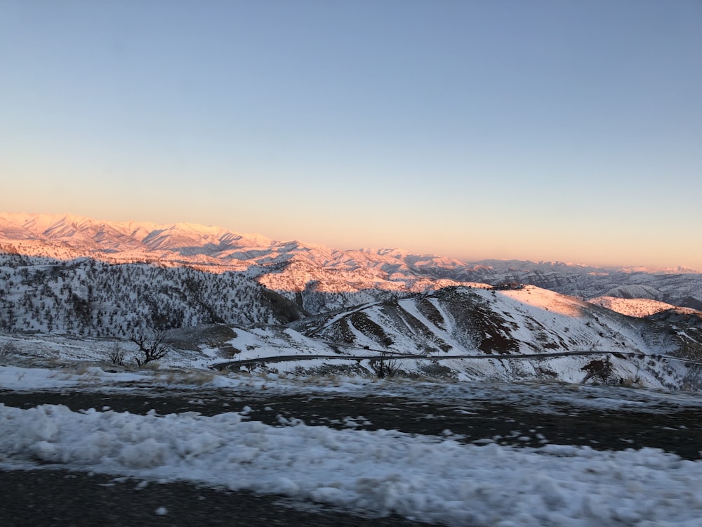 snow covered mountain during sunset