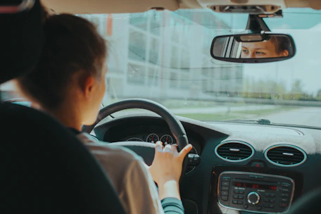 man in black shirt driving car