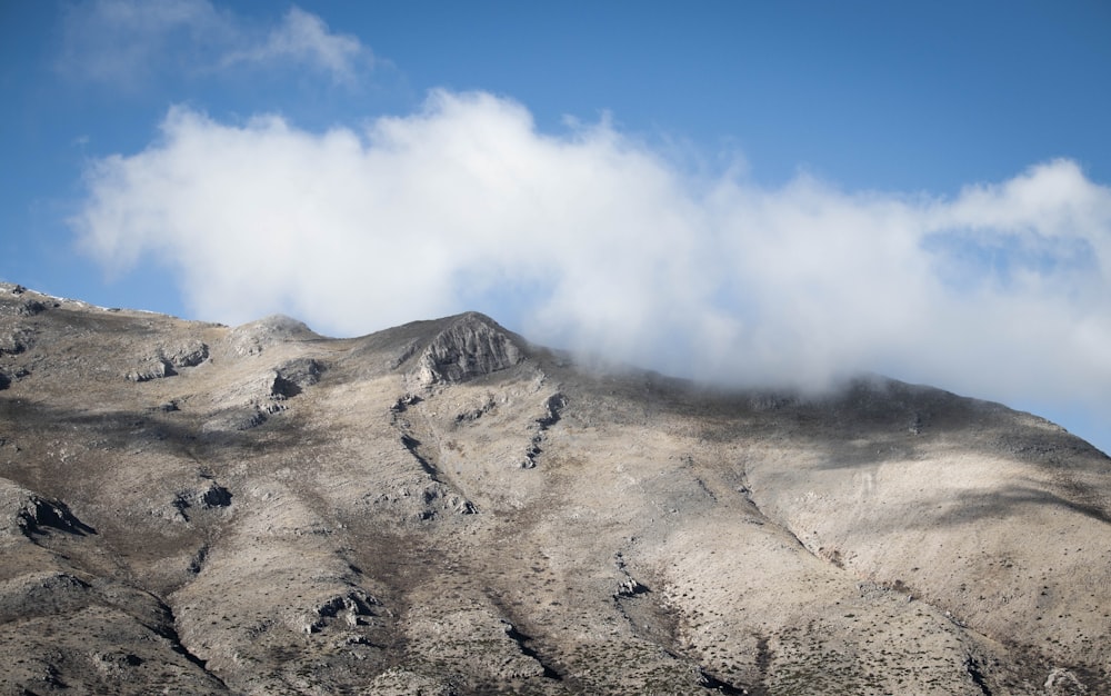 gray mountain under white clouds during daytime