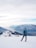 Woman with backpack pausing to admire a panoramic view of snow-capped Himalayan peaks