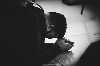 man lying on floor praying