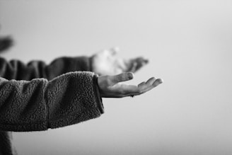 grayscale photo of persons hand