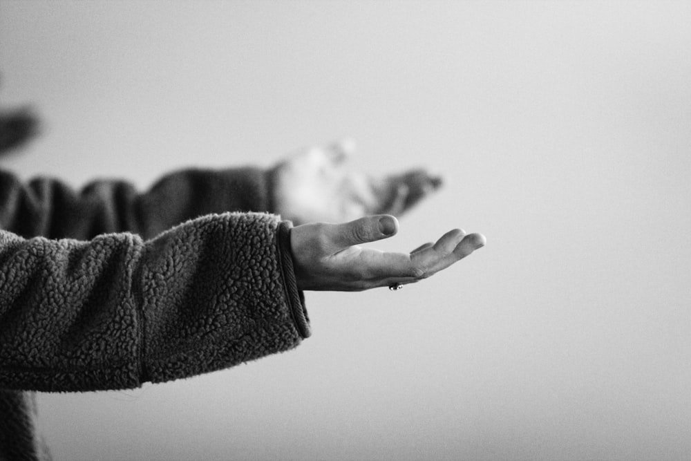 grayscale photo of persons hand