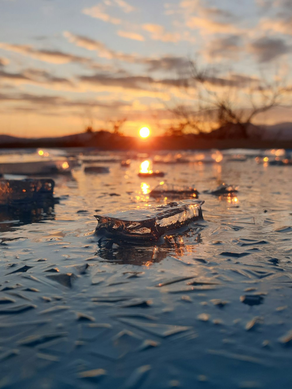 brown boat on body of water during sunset