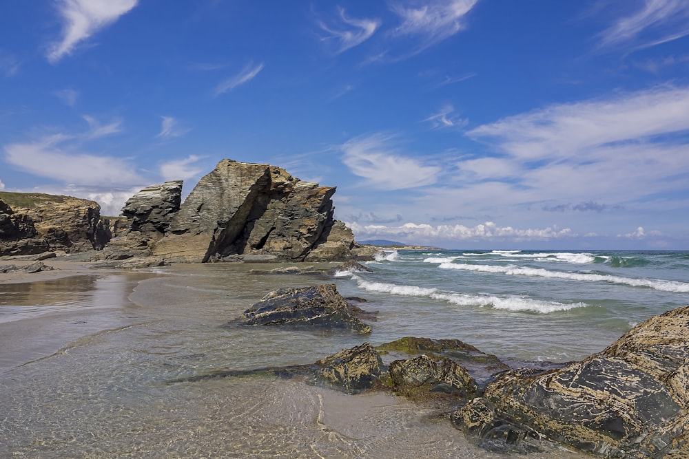 brown rock formation on sea shore during daytime