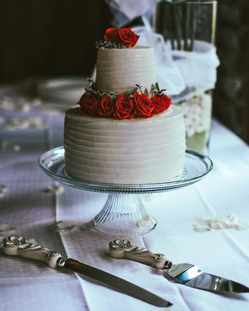 white and red cake on clear glass cake stand