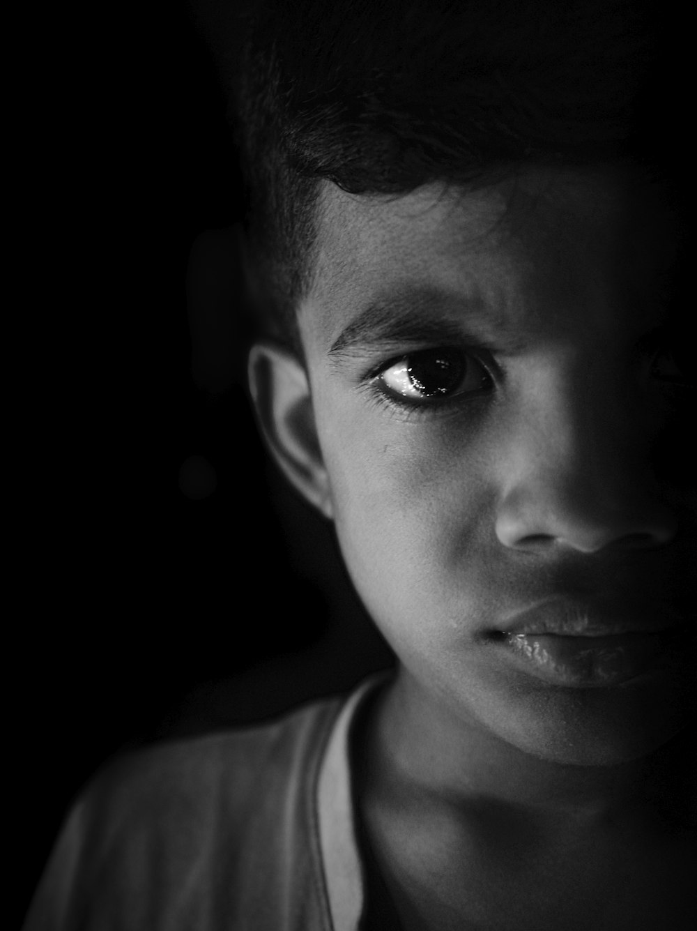 a black and white photo of a young boy