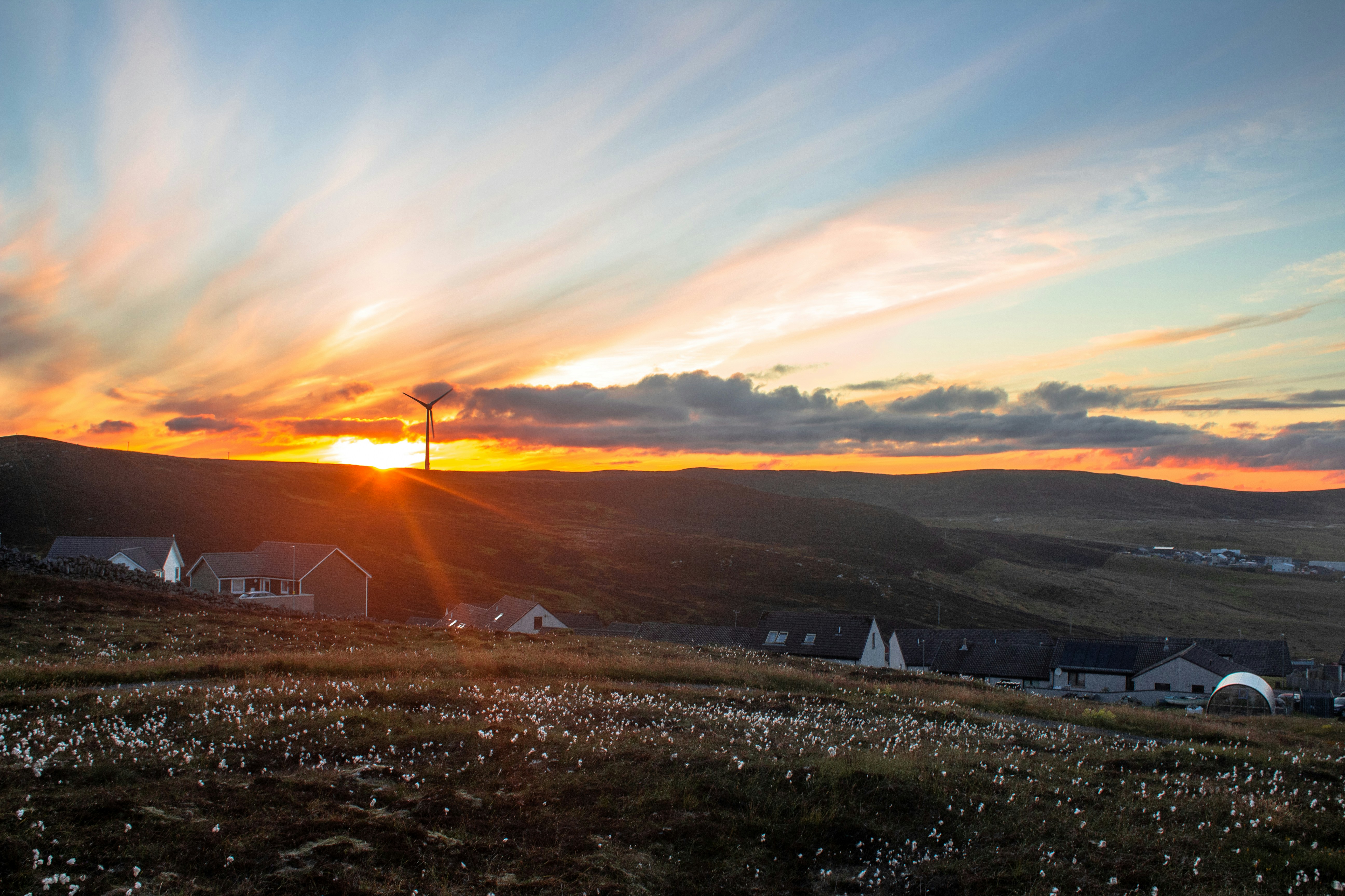 woman wearing yellow long-sleeved dress under white clouds and blue sky during daytime