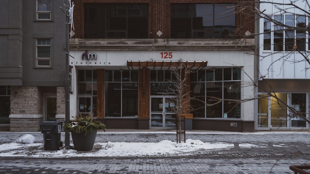 brown concrete building with snow covered ground during daytime