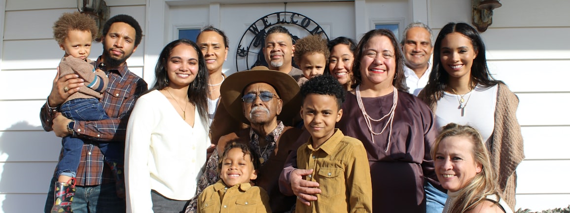 group of people standing near white building