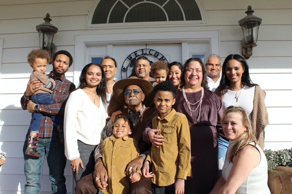 group of people standing near white building