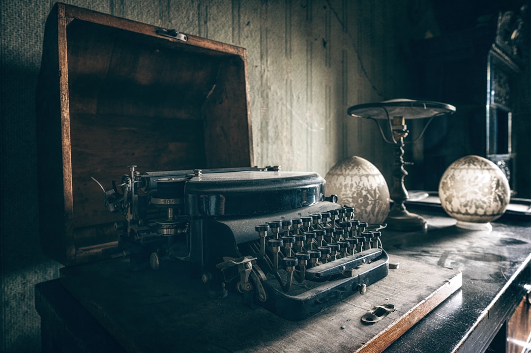 black and gray typewriter on table