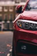 red car in front of building during daytime
