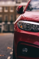red car in front of building during daytime