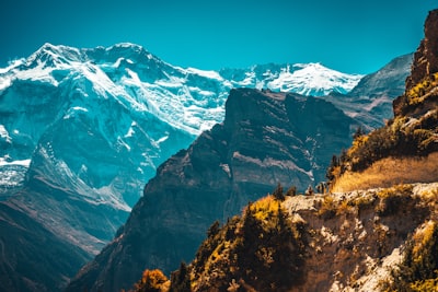 brown and green mountains under blue sky during daytime pilgrim teams background