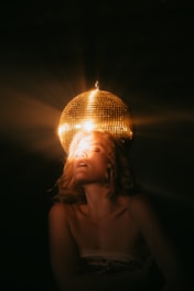 topless woman under white pendant lamp