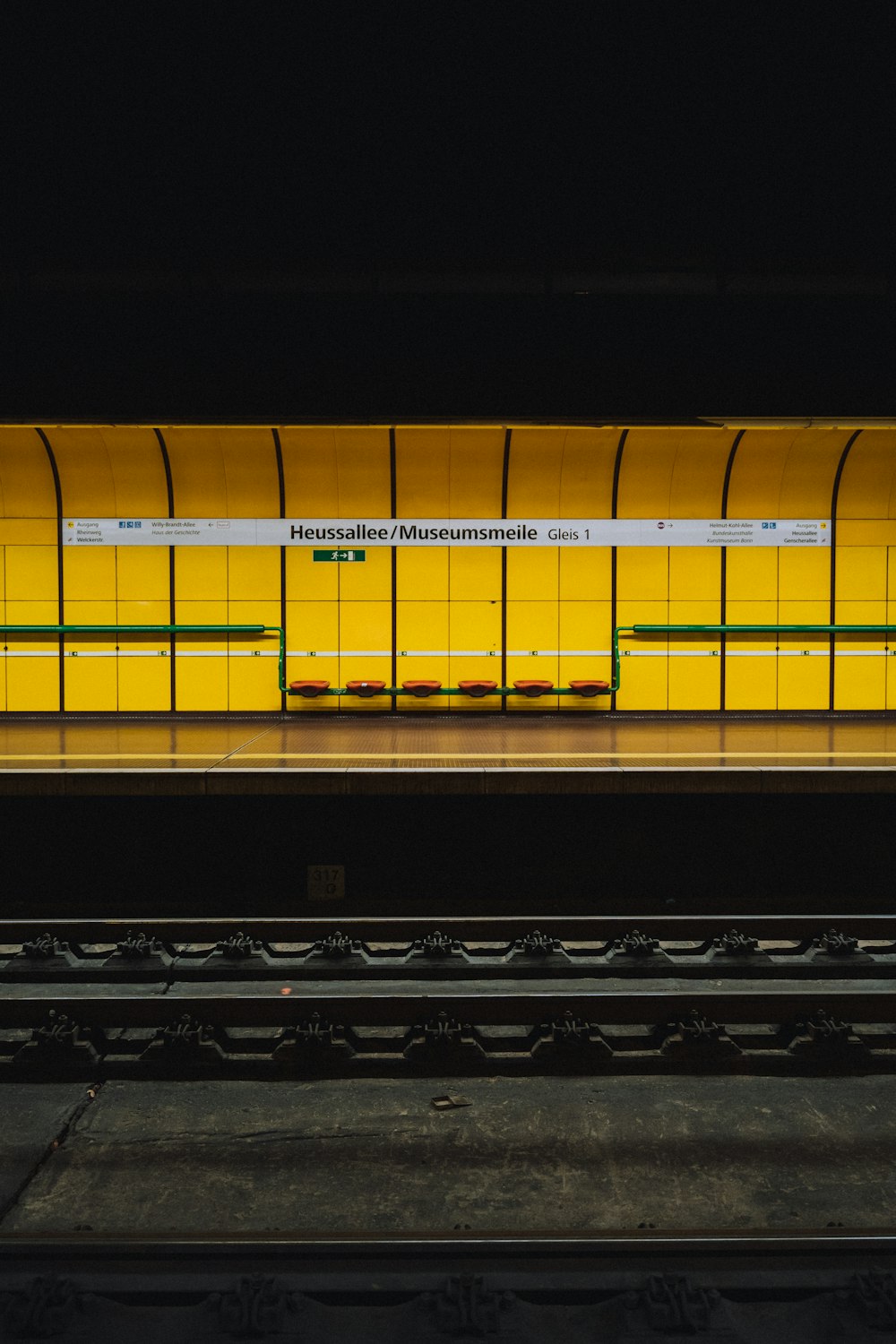 yellow and black train on rail tracks