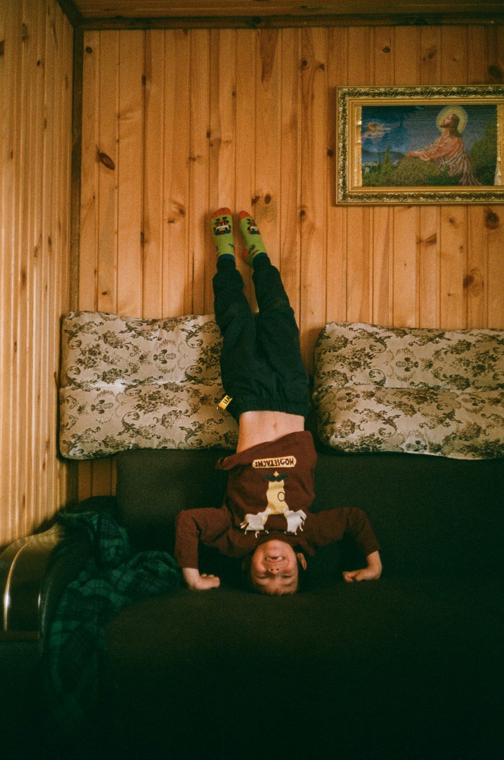 woman in red and white long sleeve shirt and black pants lying on bed