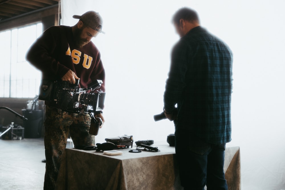 2 men standing near table